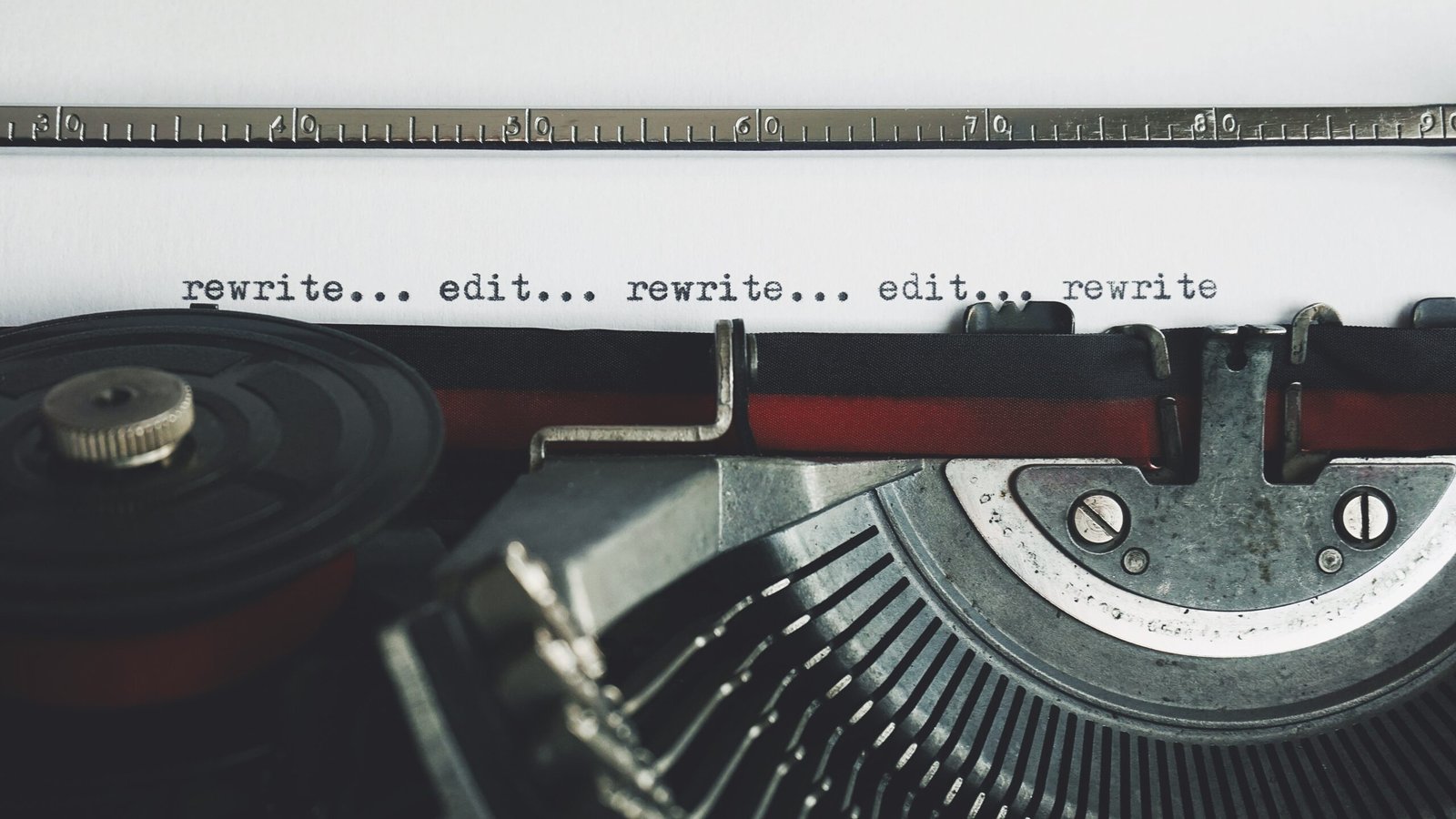 Communication skills image: typewriter spelling out "rewrite...edit...rewrite...edit".